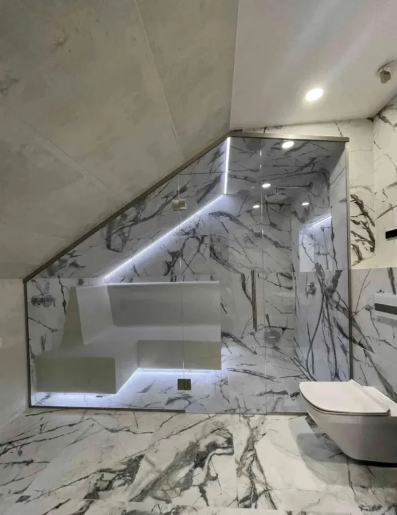 Custom-made indoor steam room finished in marble by Nordik Wellness