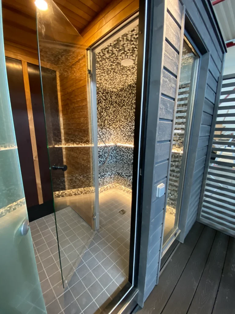 Entrance and salt-lit interior wall of the KUUT Steam outdoor steam sauna by Nordik Wellness