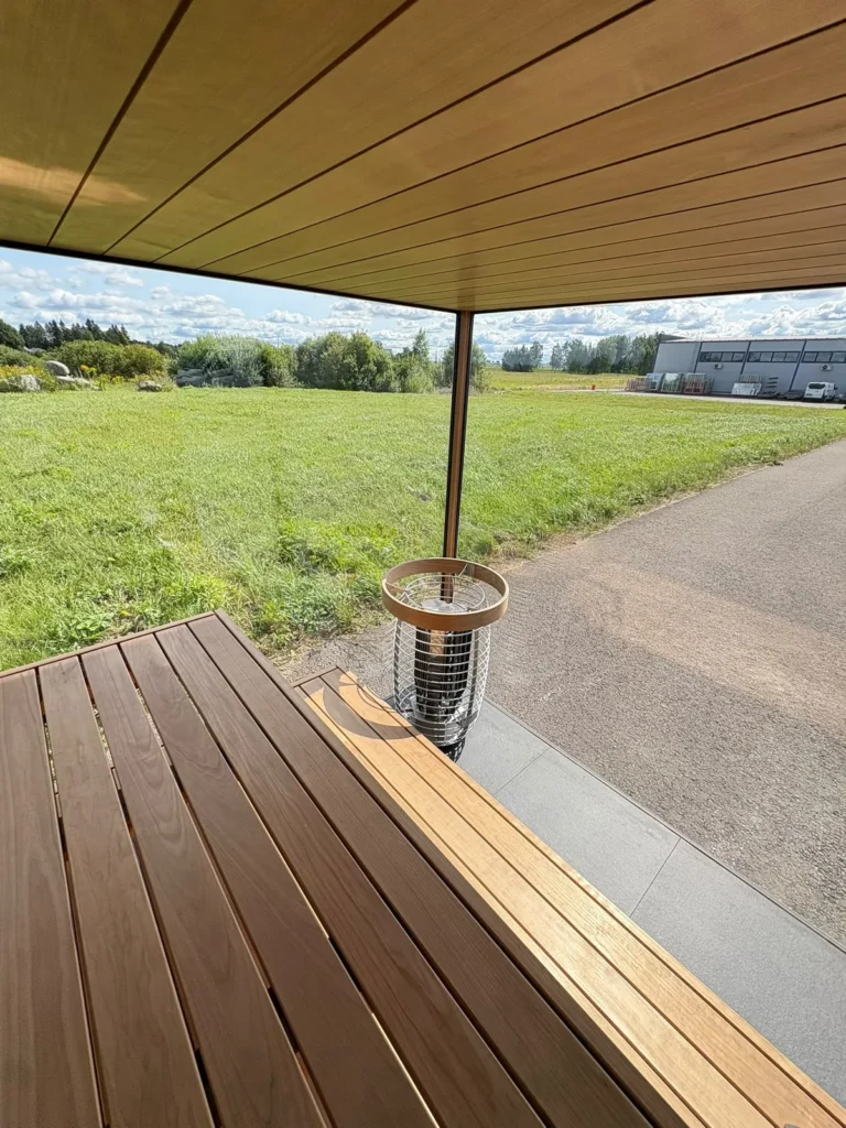 Terrace decking and heater of a new Nordik Wellness outdoor sauna, looking out over open fields