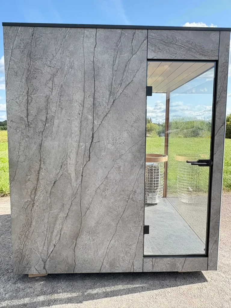 Stone-effect cladding and glass door of a new Nordik Wellness outdoor sauna
