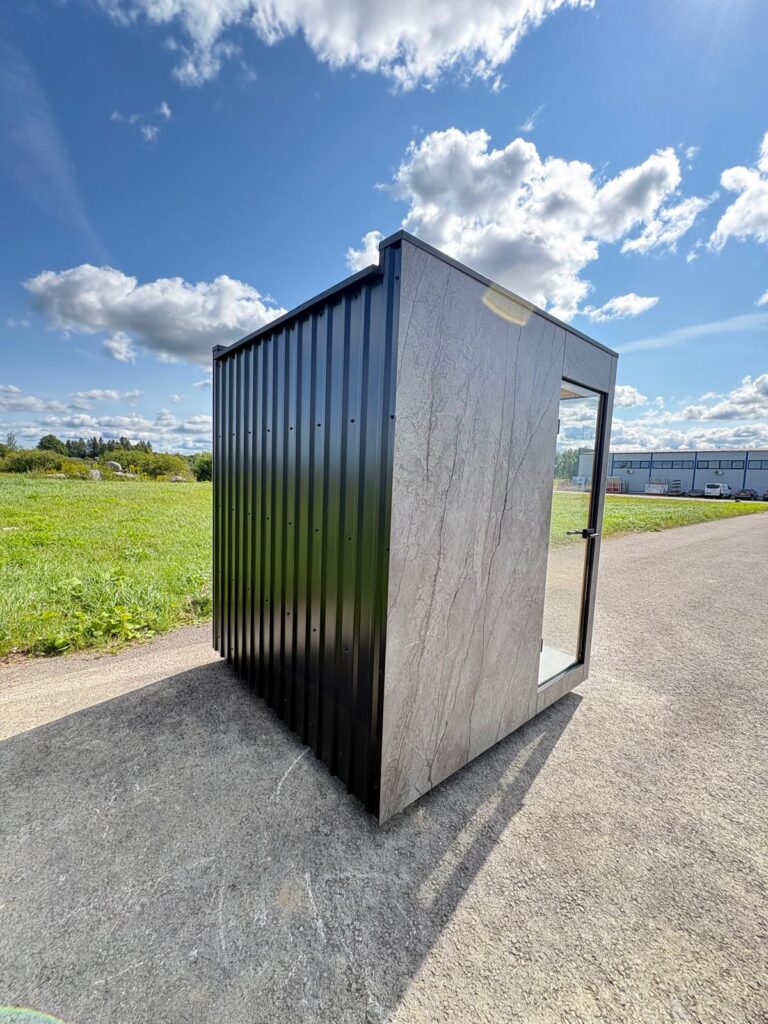 Rear of a new Nordik Wellness outdoor sauna showing the dark ribbed cladding