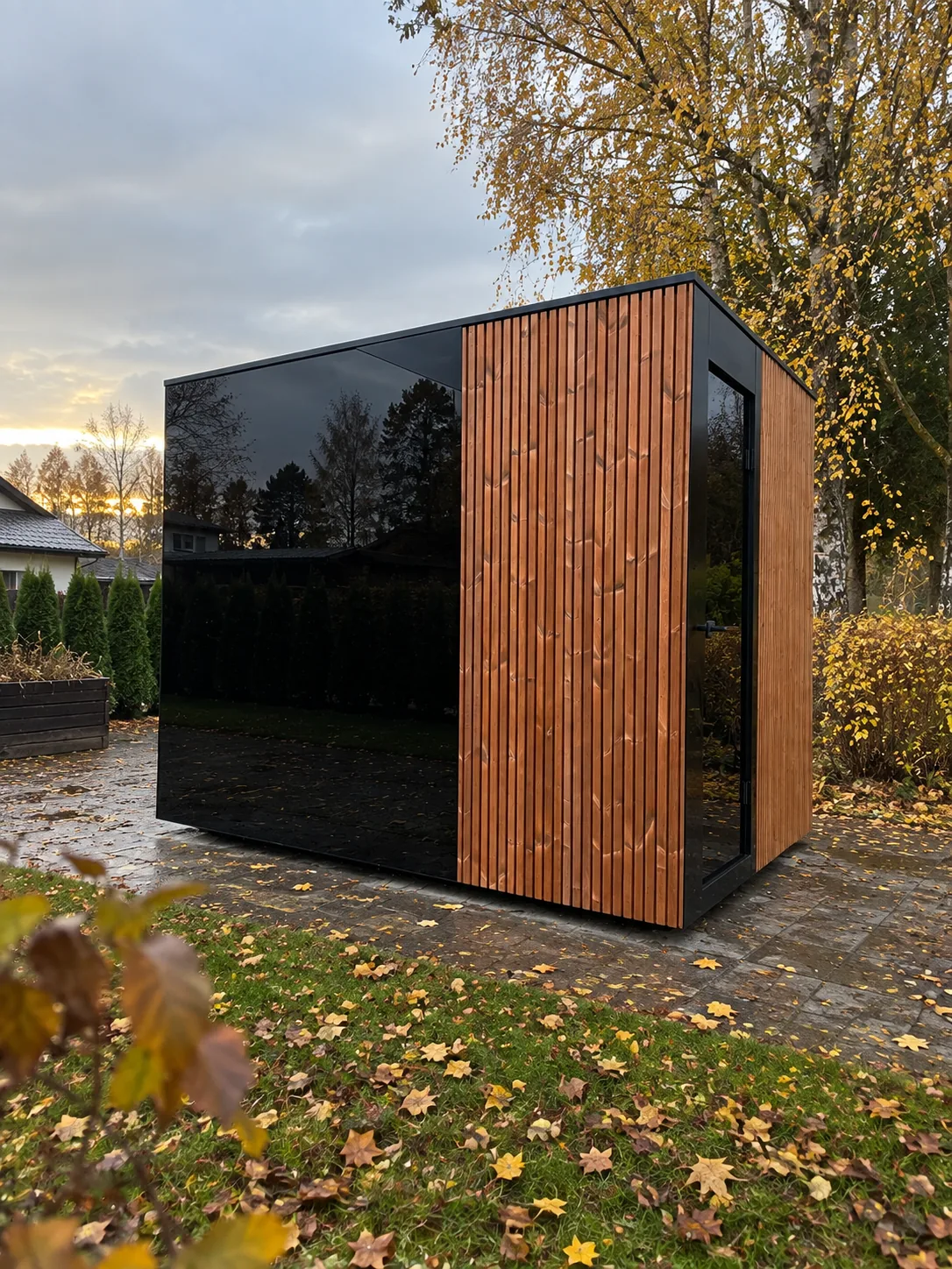Outdoor sauna with thermo-treated timber cladding in an autumn garden