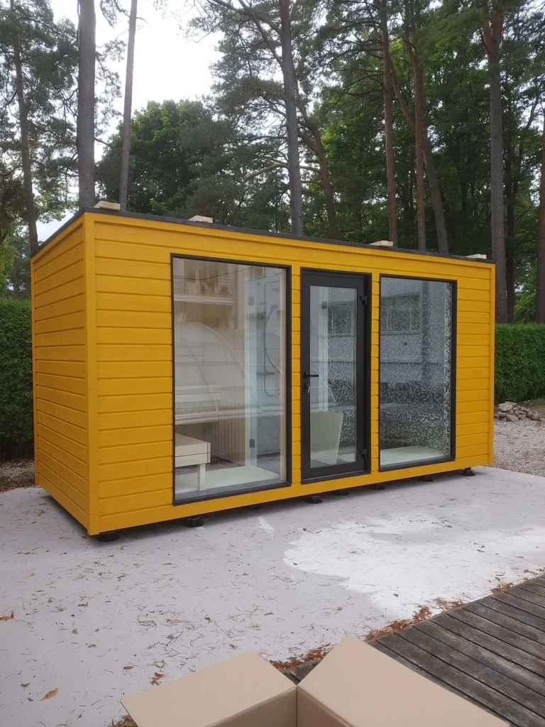 Yellow-clad garden home spa building among pine trees
