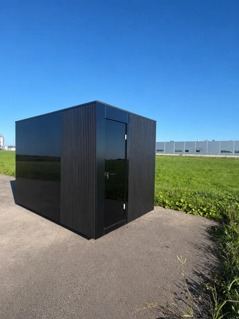 Signature L outdoor sauna with dark cladding and a glazed door