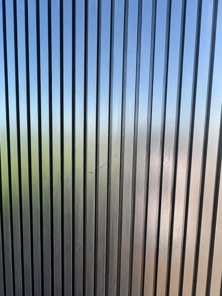 Close-up of the vertical timber and dark batten cladding on the Signature L