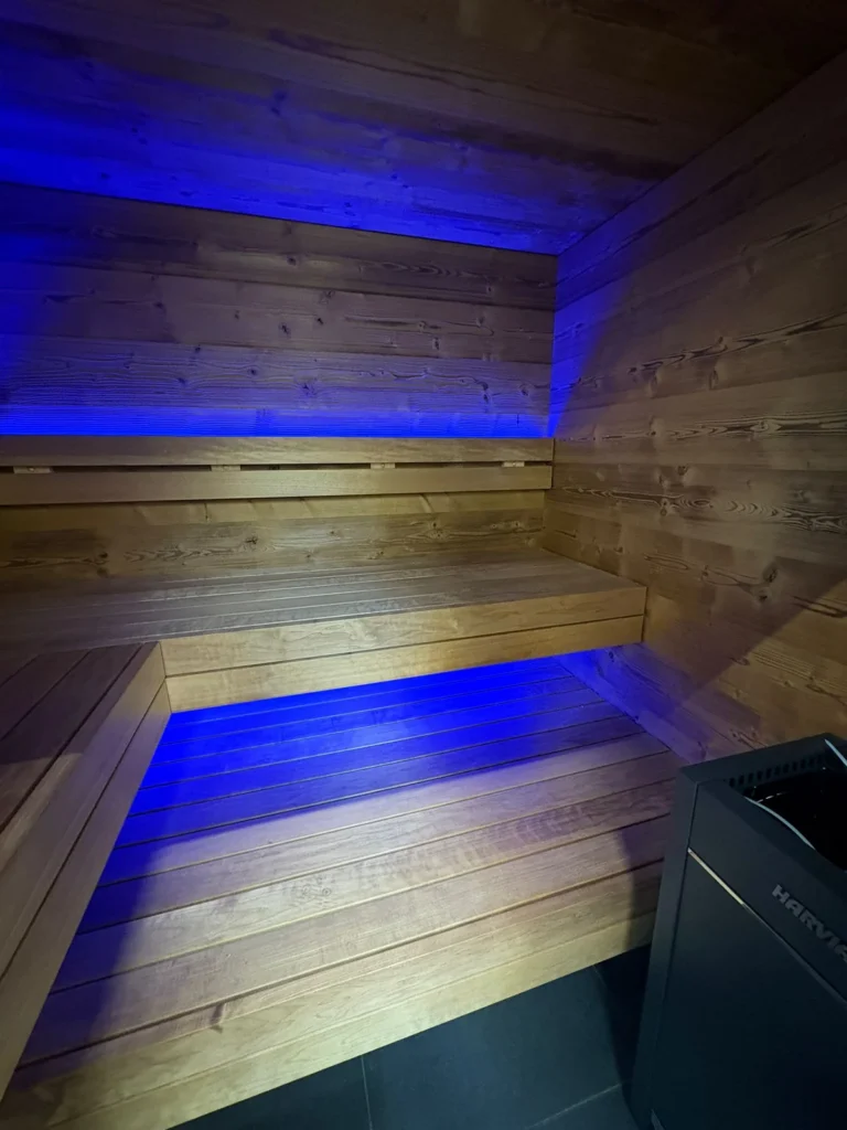 Signature M sauna interior with the bench lighting set to blue